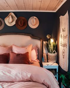 a bedroom with hats on the wall above the bed