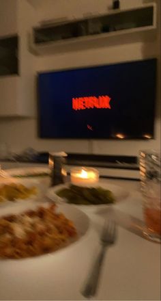 a white plate topped with food next to a tv