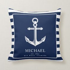 an anchor on a blue and white striped pillow