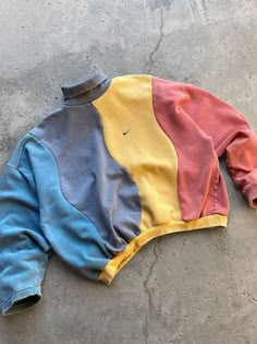 an old nike jacket laying on the ground