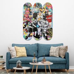 two skateboards hanging on the wall above a blue couch