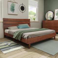 a bed room with a neatly made bed and dressers