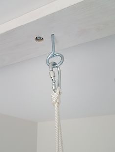 a white rope is hanging from the ceiling