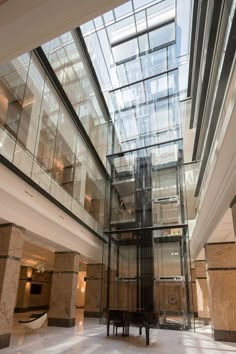 the inside of a building with glass and marble