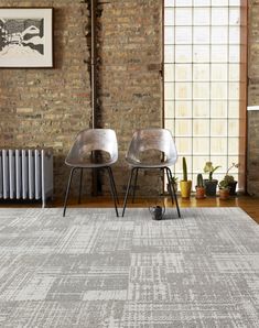 two chairs sitting on top of a rug next to a radiator