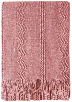 a pink blanket with fringes on it