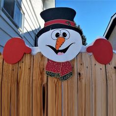 a wooden fence with a snowman on it