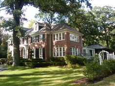 a large red brick house surrounded by trees