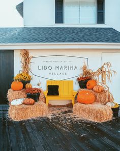 an outdoor display with hay bales and pumpkins