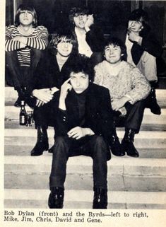 an old black and white photo of people sitting on steps with one person holding his hand to his face