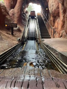 the water is running down the stairs in the cave