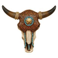 a cow skull with long horns decorated with turquoise beads and an ornate design on it's face