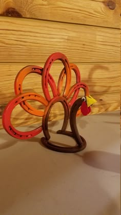 a wooden turkey sculpture sitting on top of a table next to a wood paneled wall