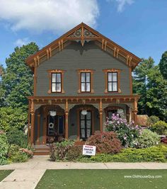 a house with a for sale sign in front of it