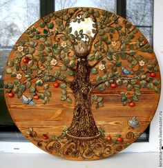 a wooden plaque with an apple tree on it