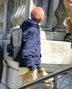 a man with a backpack walking up some stairs