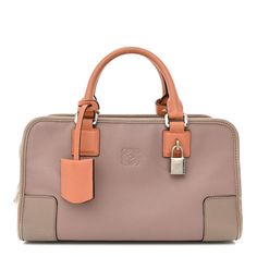 This is an authentic LOEWE Calfskin Amazona 28 in Pink and Taupe. This sophisticated tote is beautifully crafted of goatskin leather in taupe. The bag features pink orange rolled leather top handles with polished silver hardware. The wrap-around zippers open the bag to a smooth matching leather interior with zipper and patch pockets. Loewe Amazona Bag, Loewe Amazona, Orange Rolls, Puzzle Bag, Bag Light, Crystal Flower, Leather Interior, Leather Top, Silver Hardware