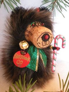 a bear ornament hanging from a christmas tree with candy canes and candies