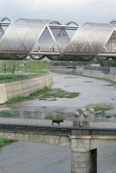 a bridge over a body of water with birds on it