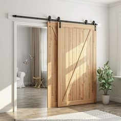 an open wooden sliding door in a white living room with potted plant on the floor