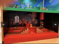 a display case with mario's castle and other items on the shelf in front of it