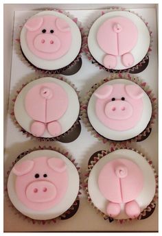 cupcakes decorated with pink frosting and fondant pig faces on top of each other