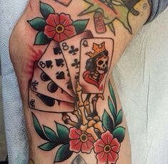 a man's leg with tattoos and playing cards on it