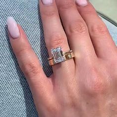 a woman's hand with pink manicured nails and an engagement ring