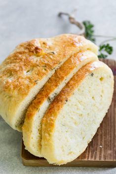 two loaves of bread sitting on top of a cutting board