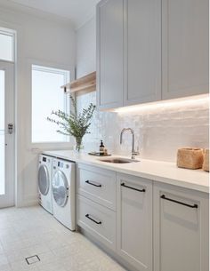 a washer and dryer in a white kitchen