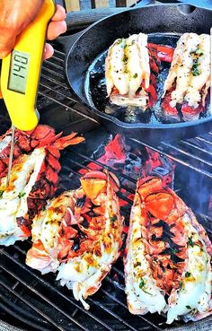 someone is cooking lobsters on the grill with a digital thermometer in their hand