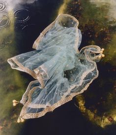 a blue dress floating on top of water