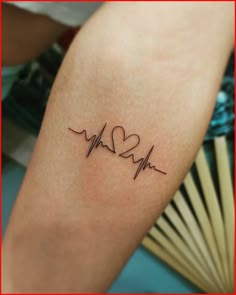 a small heartbeat tattoo on the right forearm and arm, with two hearts in it