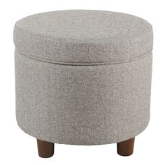 a round ottoman with wooden legs and a grey upholstered cover on the top