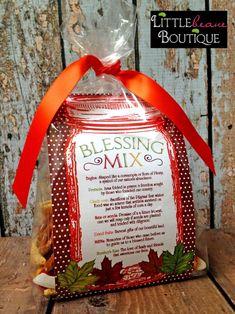 a bag with a message on it sitting on top of a wooden table next to a red ribbon