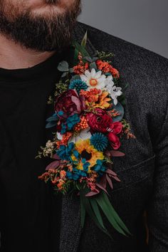 a man wearing a suit and tie with flowers on his lapel flower corsage