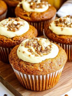 carrot muffins with cream cheese frosting and walnut sprinkles on top