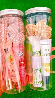 two jars filled with different types of toothbrushes and lip care products next to each other