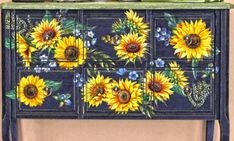 a painted dresser with sunflowers on it