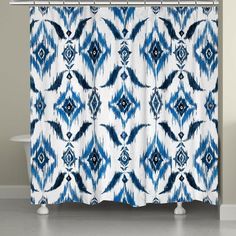 a blue and white shower curtain with an abstract design on the bottom, in front of a bathtub