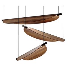 three wooden surfboards hanging from the ceiling