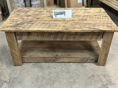 a wooden coffee table sitting on top of a floor next to other items in a store