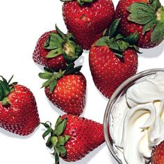 strawberries and whipped cream on a white background