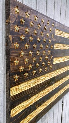 an american flag made out of wooden planks on the side of a barn wall