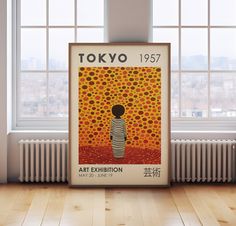 an art exhibition poster in front of a window