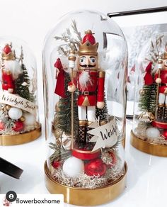 three snow globes with nutcracker figurines in them