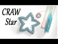 some beads are laying next to a star shaped object with the words craw star on it