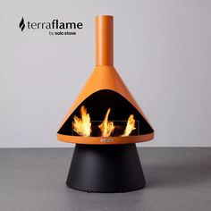 an orange and black fire pit sitting on top of a table