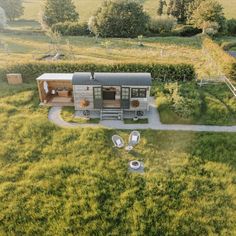 an aerial view of a tiny house in the middle of a field