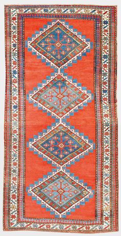 an orange, blue and red rug with geometric designs